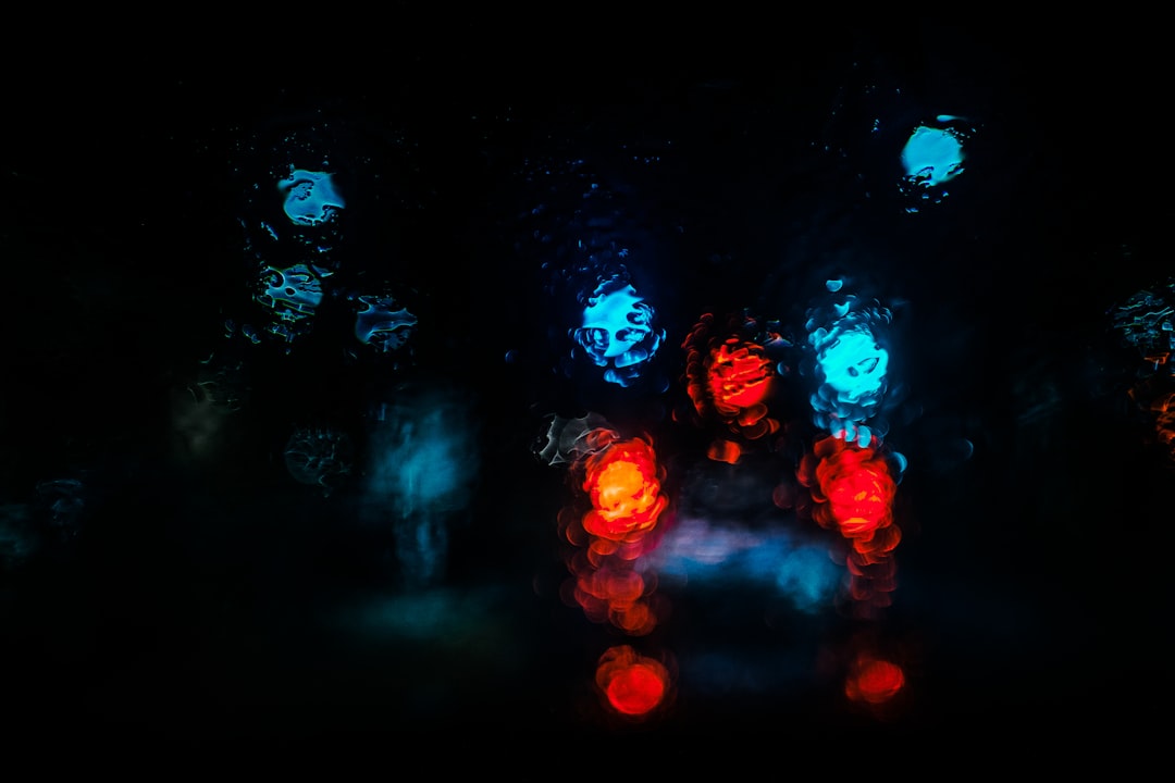 Red and blue lights blurred in darkness, illustrating a signal emerging from noise